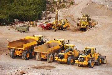 Fotobehang Vrachtwagen Large lorry trucks and tractors in a quarry  © monstersparrow