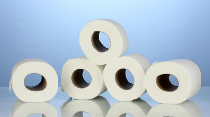 rolls of toilet paper on blue background