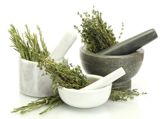 mortars with fresh green thyme and rosemary isolated on white