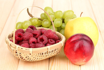 ripe sweet fruits and berries on wooden background
