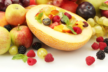 fresh fruits salad in melon, fruits and berries, isolated