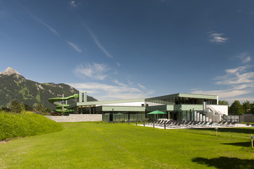 new modern public swimming bath with mountains and green grass