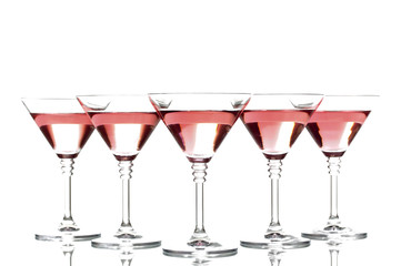 Red cocktail in martini glasses isolated on white