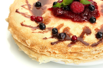 Delicious pancakes with berries and jam