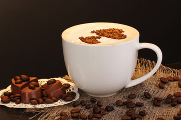 Latte on wooden table on brown background