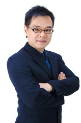 Good looking asian business man standing with arms folded.