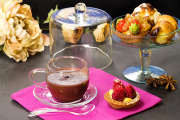 chocolate cup with fancy cakes and floral decorations