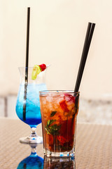 summer drinks - mojito with strawberries and blue lagoon