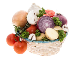 Basket with vegetables on white