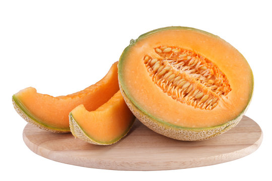 sliced piece cantaloupe melon on wooden carving board