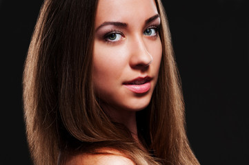 attractive young woman over dark background