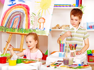 Child painting at easel.