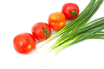 tomatos and leeks on white paper