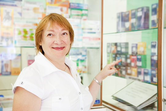woman chooses contraceptives at pharmacy