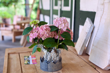 Composition of pink flowers in outdoor restaurant