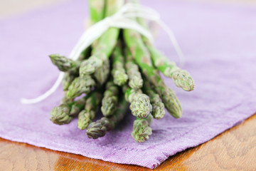Green asparagus on purple napkin
