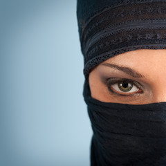 Portrait of veiled woman, focus on eyes.