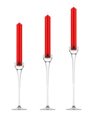 three glass candlesticks with red candles isolated on white