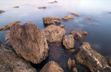 Sea water and big boulders. Landscape