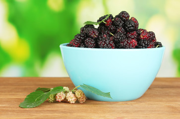 Blue bowl with ripe mulberries
