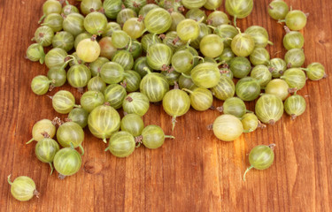 Green gooseberry on wooden background