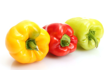 fresh yellow, red and green bell peppers isolated on white