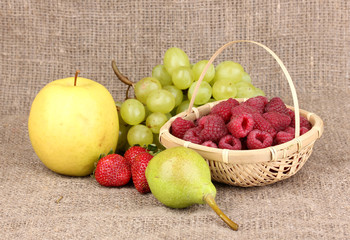 ripe sweet fruits and berries on sackcloth