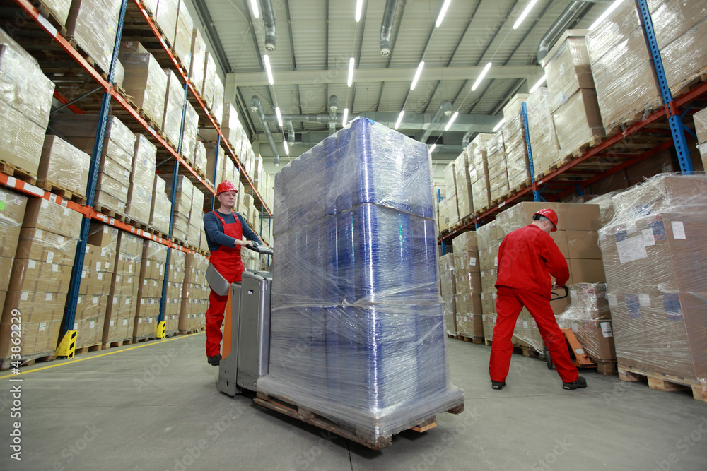 Wall mural warehousing - two workers in uniforms working in storehouse