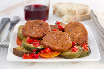 meatballs with vegetables and glass of red wine