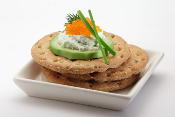 Crispbread with  salmon caviar isolated on white background