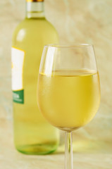 Glass and bottle of fine italian white wine, closeup