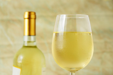 Glass and bottle of fine italian white wine, closeup