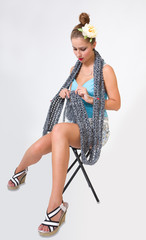 beautiful fashion pin up woman knitting scarf
