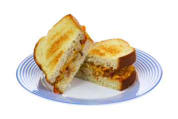 Cut chicken sandwich on blue plate