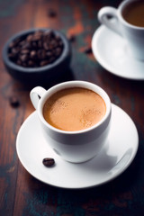 Cup of espresso coffee on dark wooden background