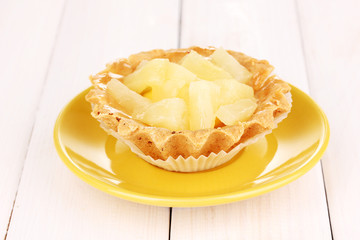sweet cake with fruits on wooden background