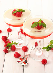 fruit jelly with berries in glasses on wooden table