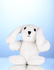 Toy bunny on blue background
