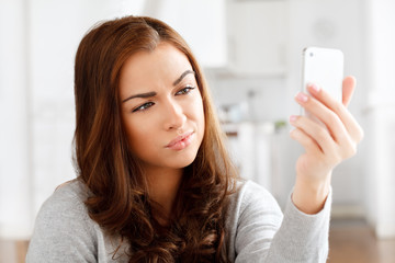 Pretty young woman using mobile phone