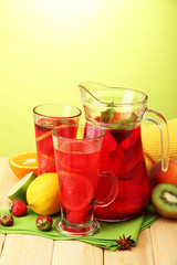 sangria in jar and glasses with fruits,