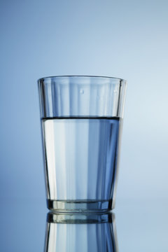 Glass of mineral water  on blue background