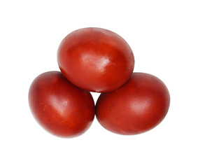 three red Easter eggs on a white background