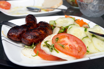 Sauceges with mozarella and vegetable salad