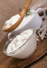 cottage cheese in a plate and a spoon with cottage cheese