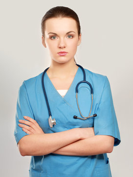 Young nurse standing with folded arms