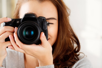 Pretty woman is a proffessional photographer with dslr camera