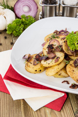 Portion of fried Potatoes with raw ingredients