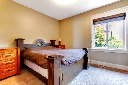 Simple classic new bedrom with nice bed and dresser.