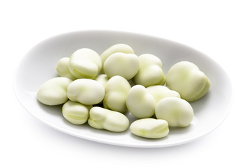 broad beans in a white dish isolated