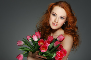beautiful young redheaded girl with tulips